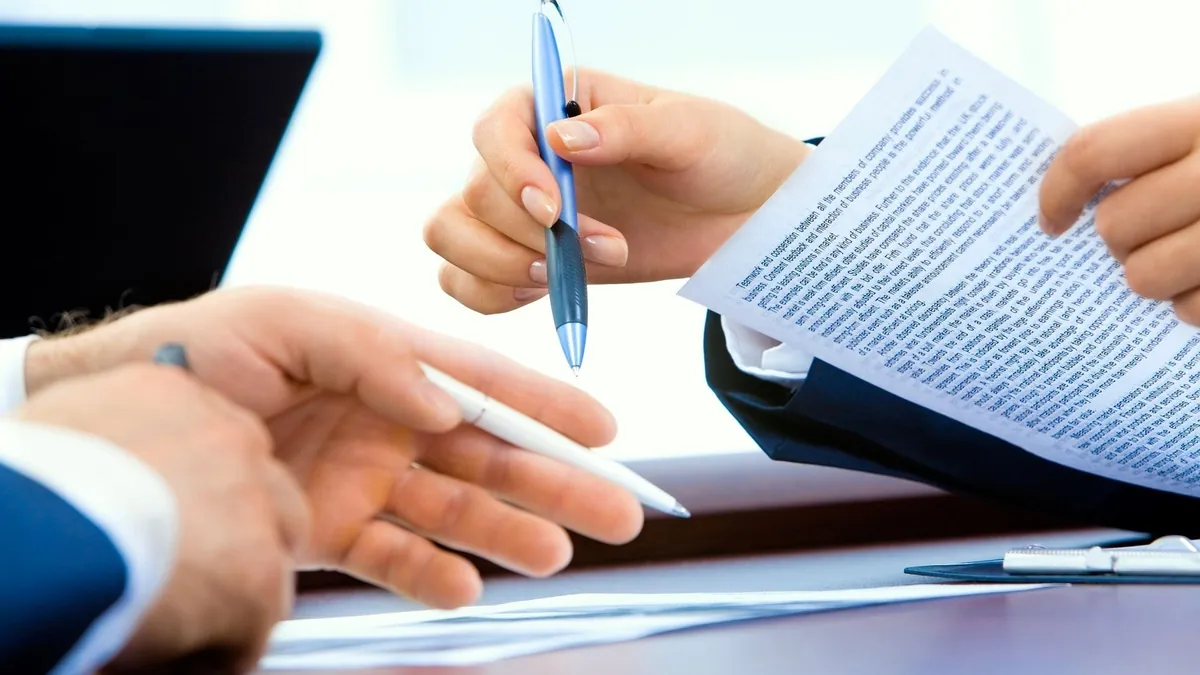 Borrower and financial adviser reviewing a loan settlement agreement